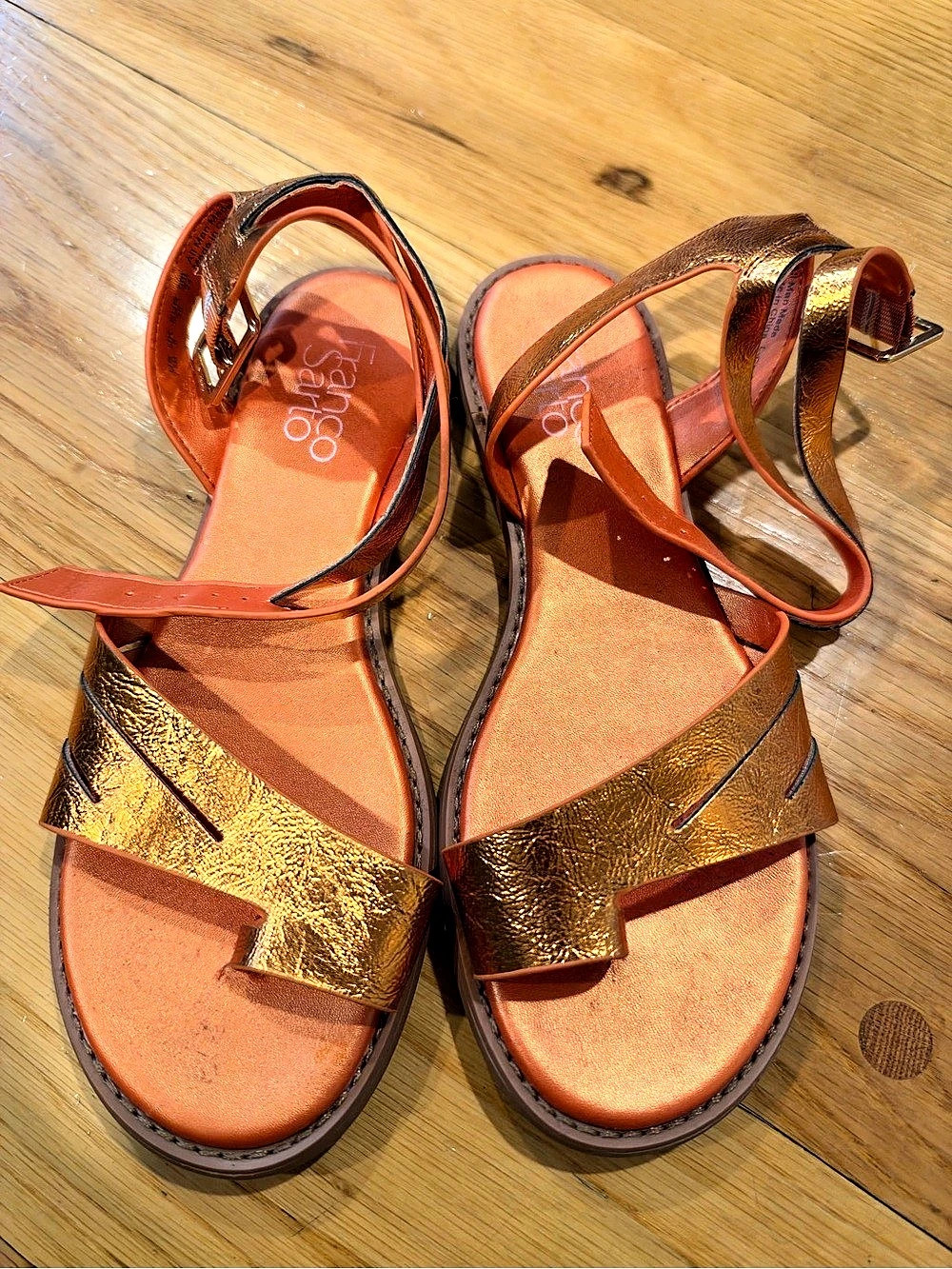 Franco Sarto Ruth Ankle Strap Thong Flat Sandal in Metallic Orange.